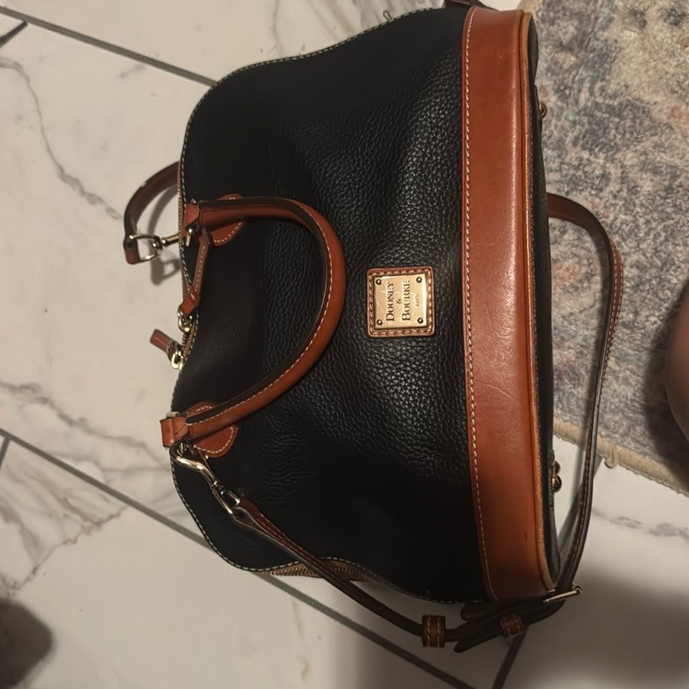 Dooney & Bourke Black & Brown bag. Red interior. Used, good condition.